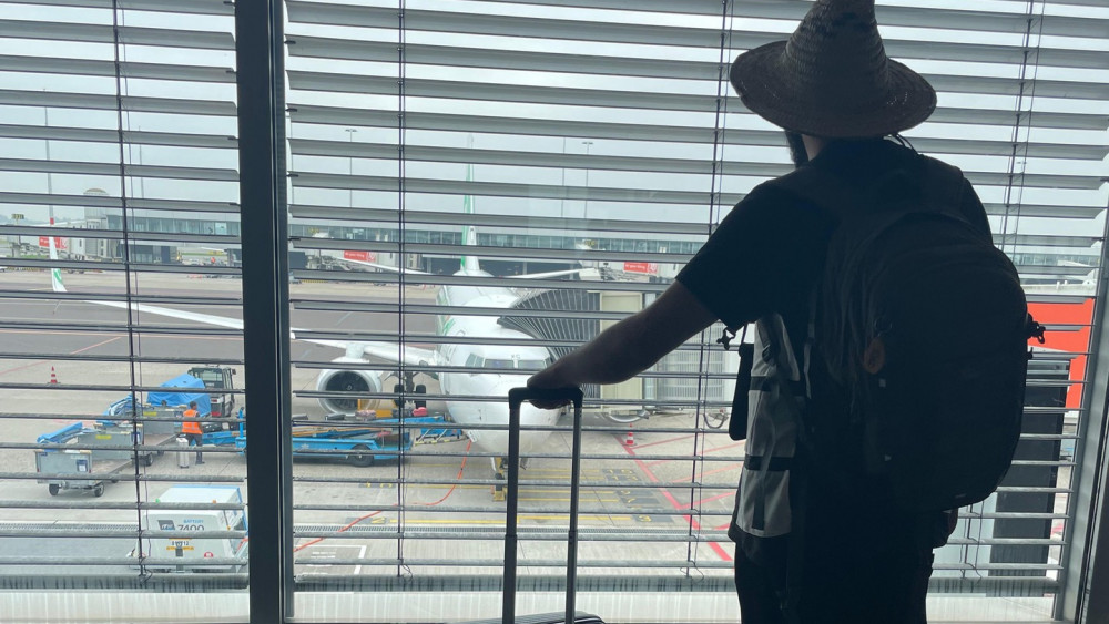 Soufian kijkt uit het raam op het vliegveld