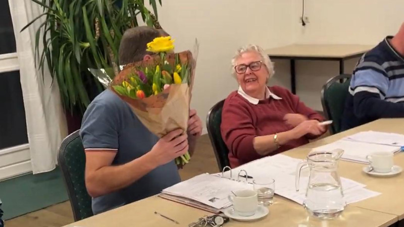 Henny van Son krijgt een bosje bloemen voor haar jarenlange inzet