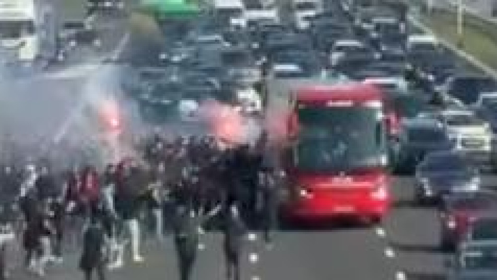 Ajax fans walk onto A4 to wave off team bus