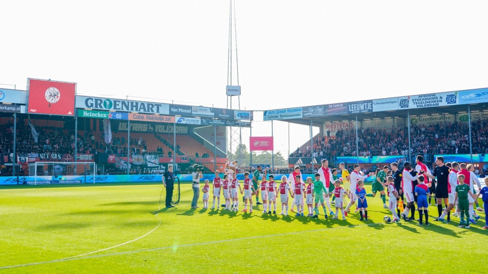 Two Ajax fans who threw stones at police to remain in custody longer