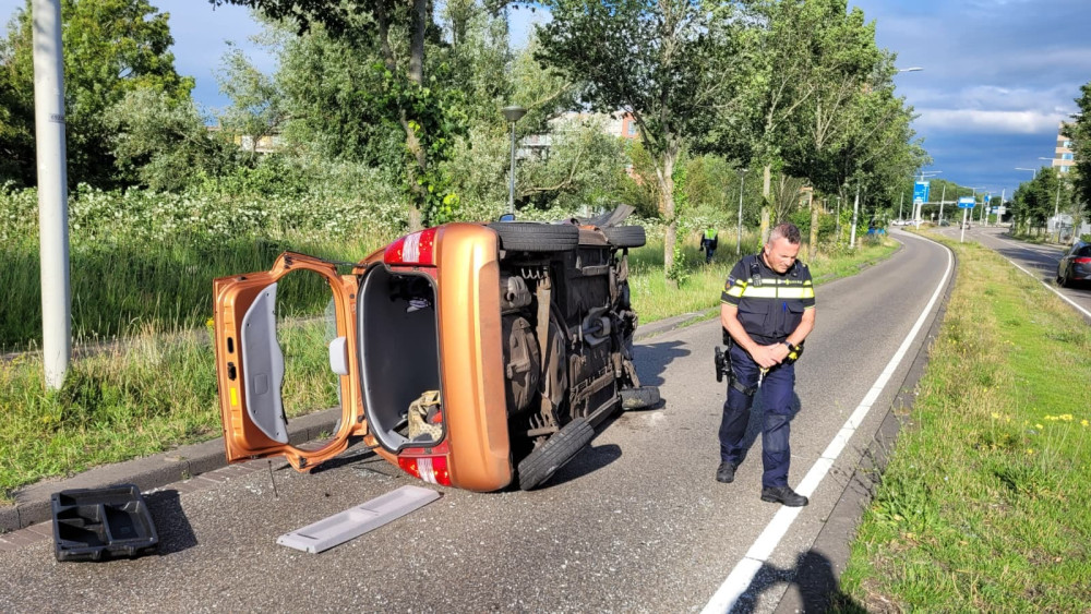 Car hits tree and ends up on its side in North
