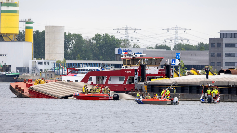 Police believe missing crew member of sunken tugboat in harbor has died