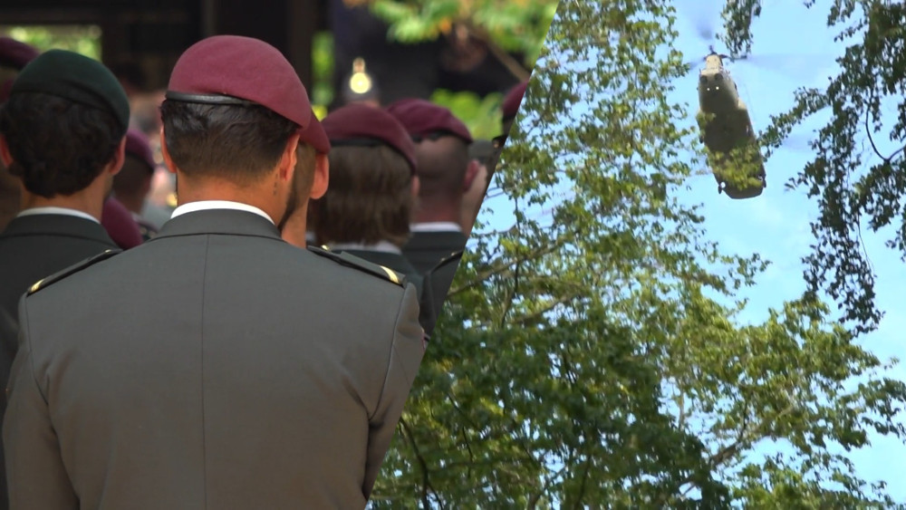 Chinook helicopters fly over and guard of honor during funeral of fallen soldier