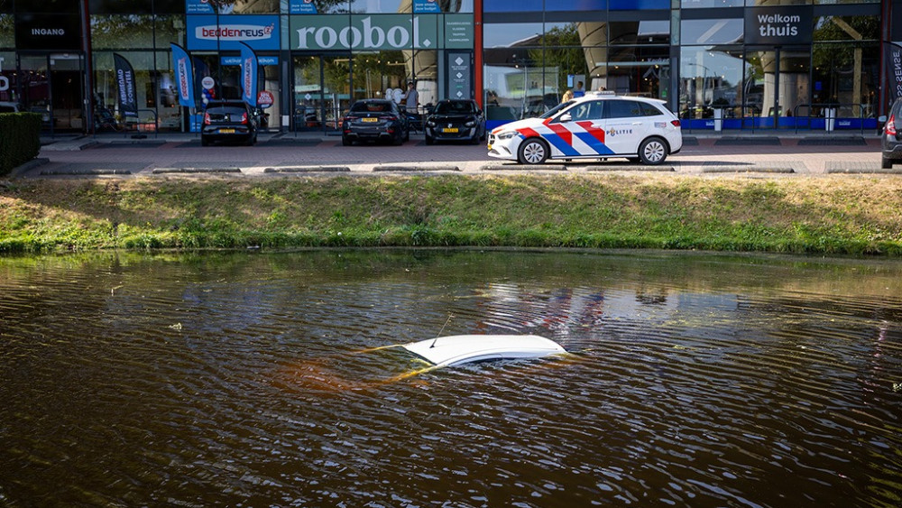 Car rolls from parking lot into the water at furniture district