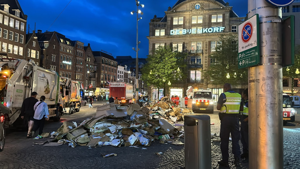 Large pile of waste on Dam Square after garbage truck fire
