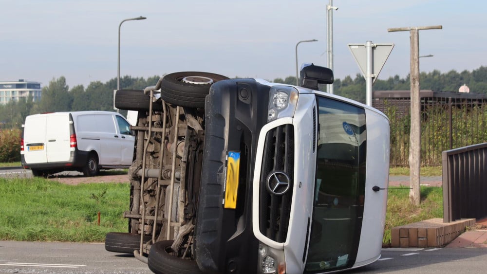 Van tipped onto its side after collision with car
