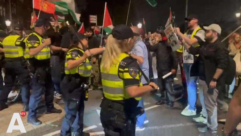 Police draw batons to hold back pro-Palestinian protesters