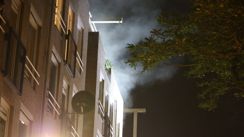 Fire in Amsterdam home, two people treated in ambulance